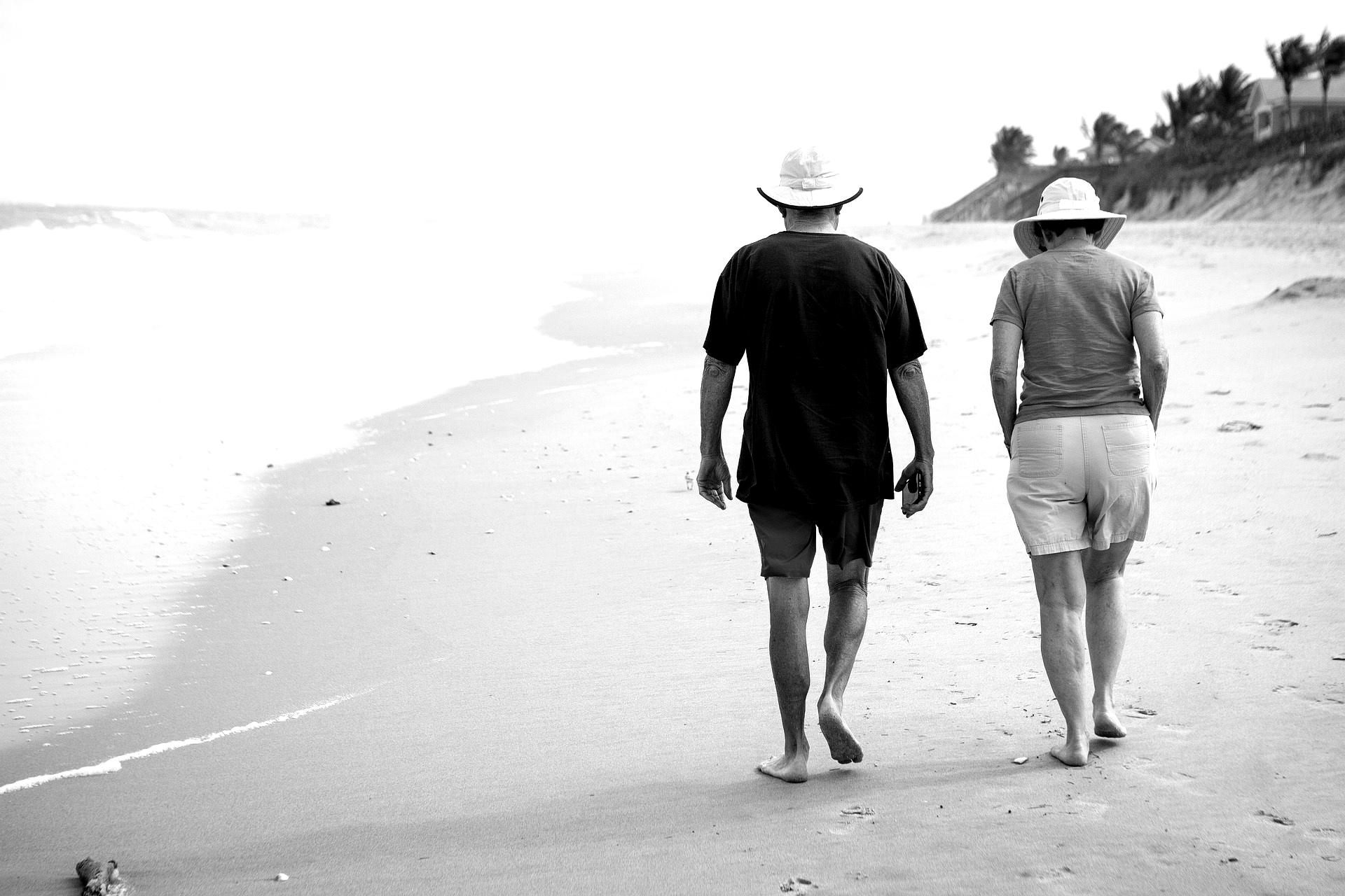 Executive pension walking on the beach black and white